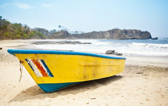 Costa Rica Vacation Packages - Boat in White Sand Beach